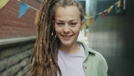woman with dreadlocks in an urban setting