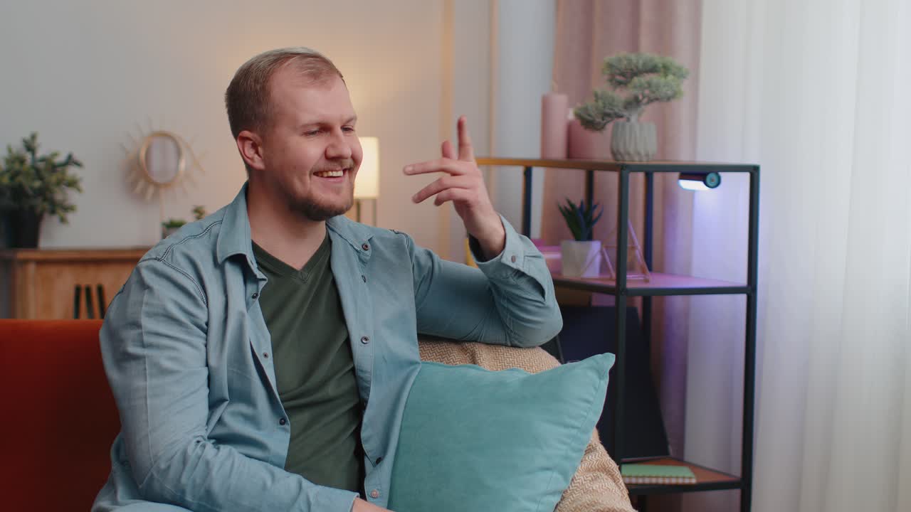 Happy calm adult caucasian bearded man smiling looking away dreaming resting feel satisfied at home