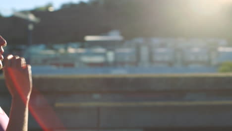 woman runner resting on a bridge