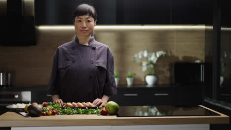 asian chef preparing sushi in modern kitchen