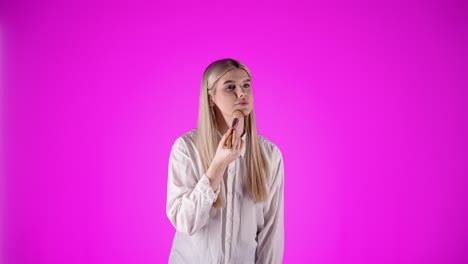 Polish-woman-applies-makeup-and-smiles-to-the-camera,-studio-shot