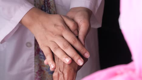 doctor comforting an elderly patient