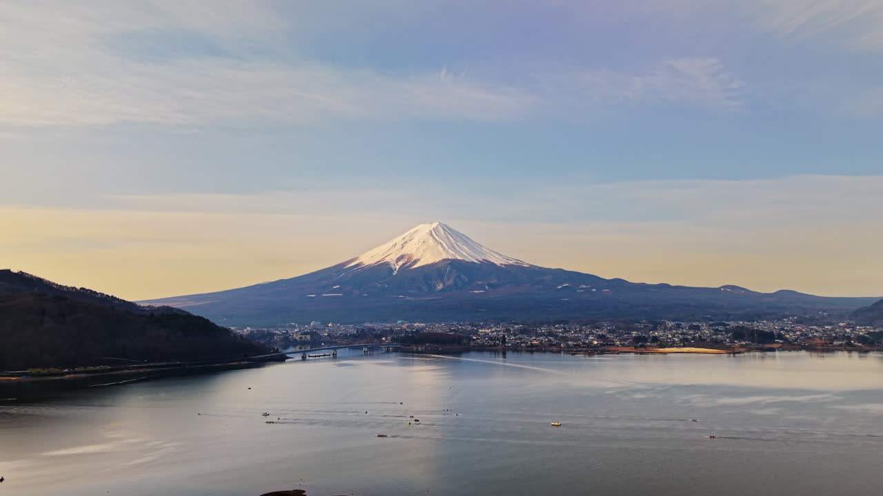 Aerial drone view of boats moving on Lake Kawaguchiko near the Fujikawaguchiko town, Japan with Mount Fuji on the background