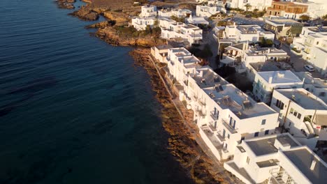 epic drone shot of flying away from naoussa village towards the sea on the island of paros, greece