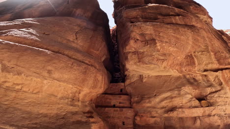 masonry with several holes among the huge sandstones curved by the wind. on the way to petra along the al siq canyon.