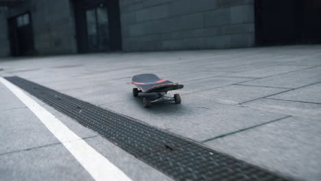 longboard rolling across sidewalk. skateboard riding outside. sports concept.