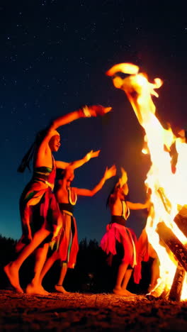 tribal dance around a bonfire under a starry sky