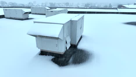 snow covered rooftop hvac units against snowy roof