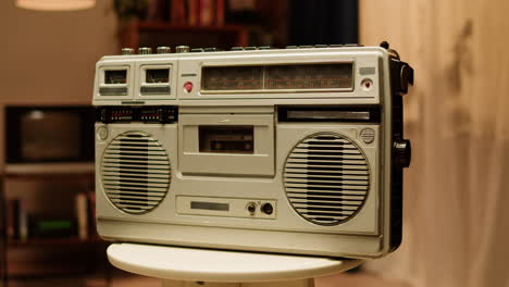 person inserting cassette into a vintage boombox