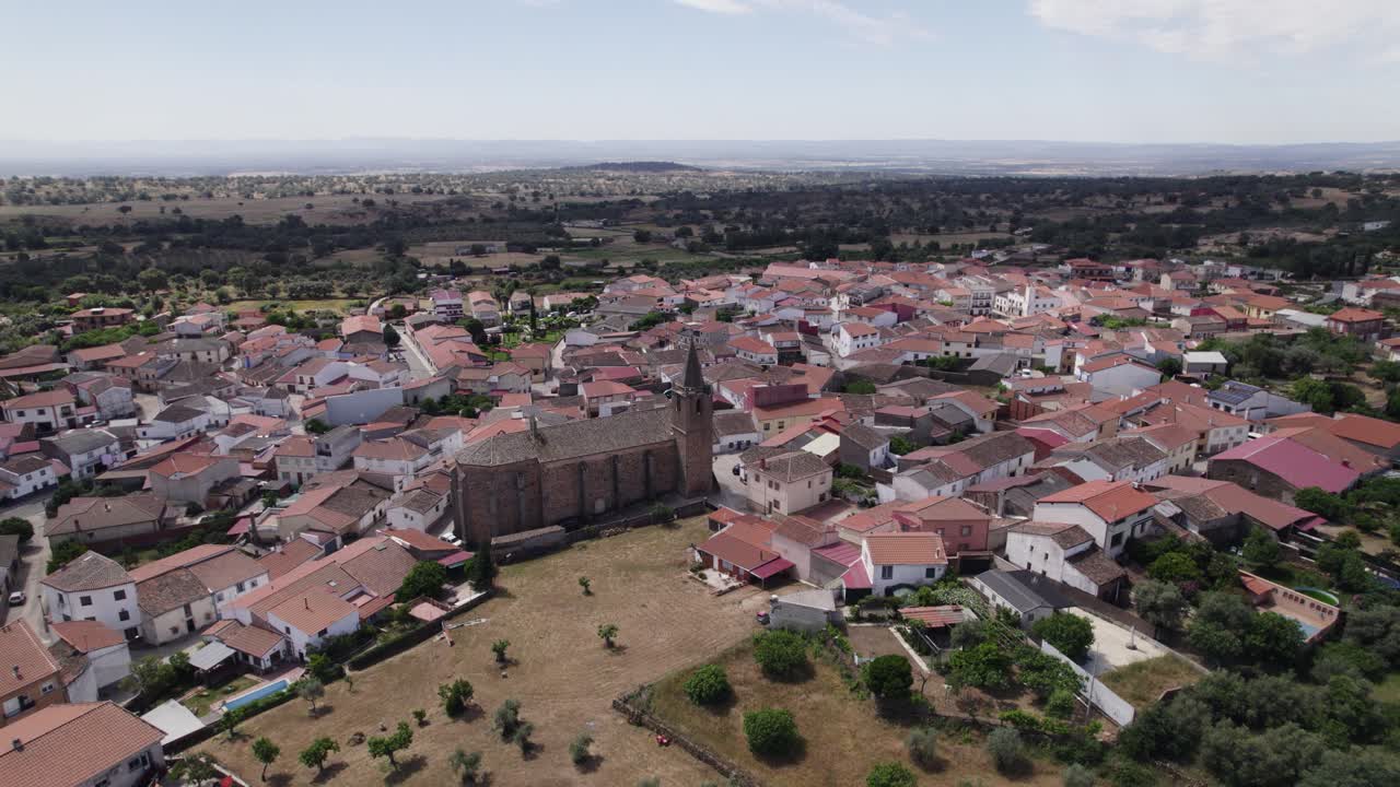 Aerial over Tejeda de Tietar's unique San Miguel Arc&aacute;ngel church, Spain