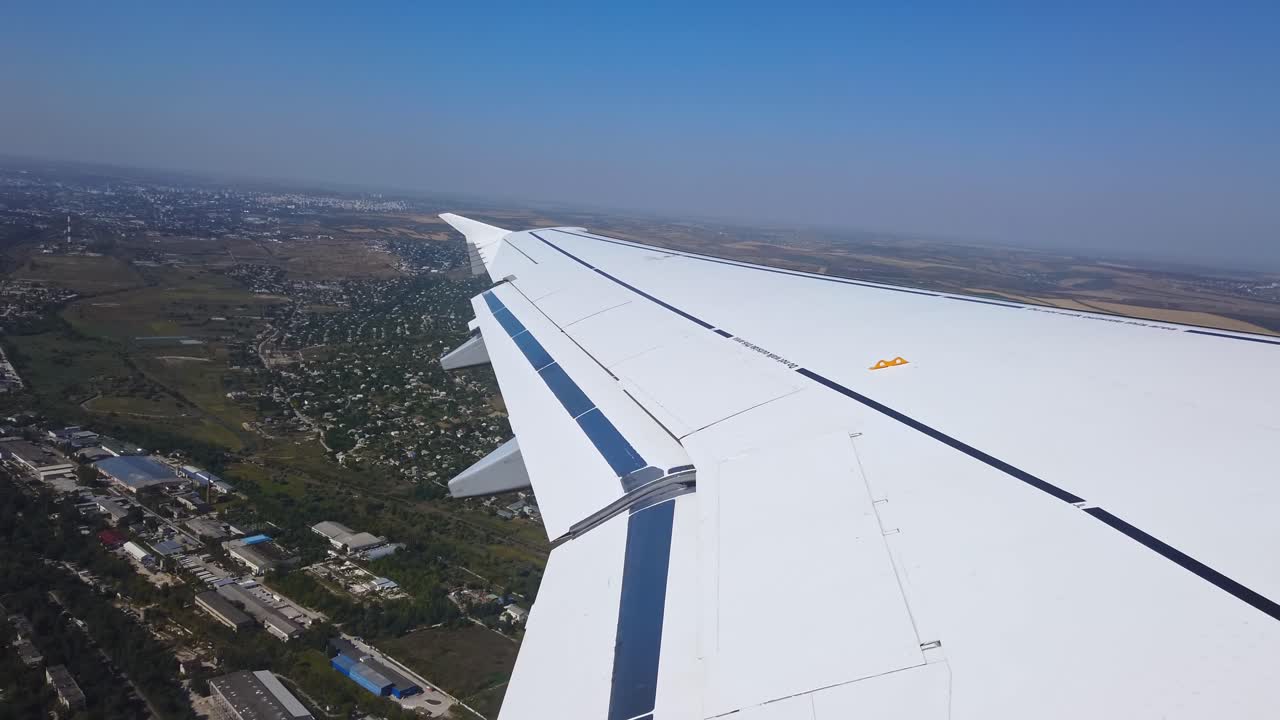 Airplane take off above a forest and houses