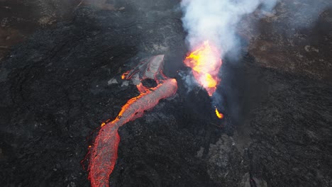 Aerial-view-over-the-volcanic-eruption-at-Litli-Hrutur,-Iceland,-with-lava-and-smoke-coming-out