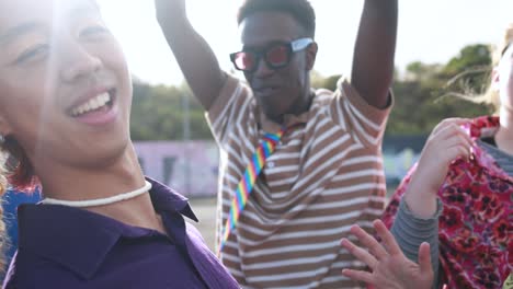 happy young people dancing outdoor at festival event - party and entertainment concept