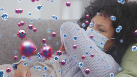 Animation-of-coronavirus-cells-over-mixed-race-woman-coughing-at-home