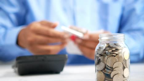 saving money with coins in a jar