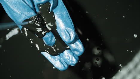 oil spill on blue gloves