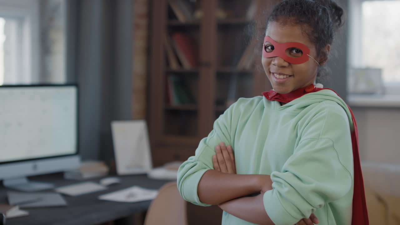 Portrait Of Mixed-Race Girl In Superhero Mask