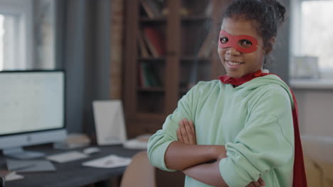 portrait of mixed-race girl in superhero mask