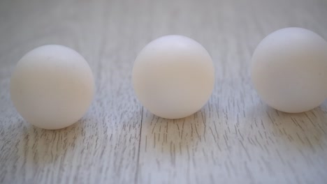 white chicken eggs on a white wooden background