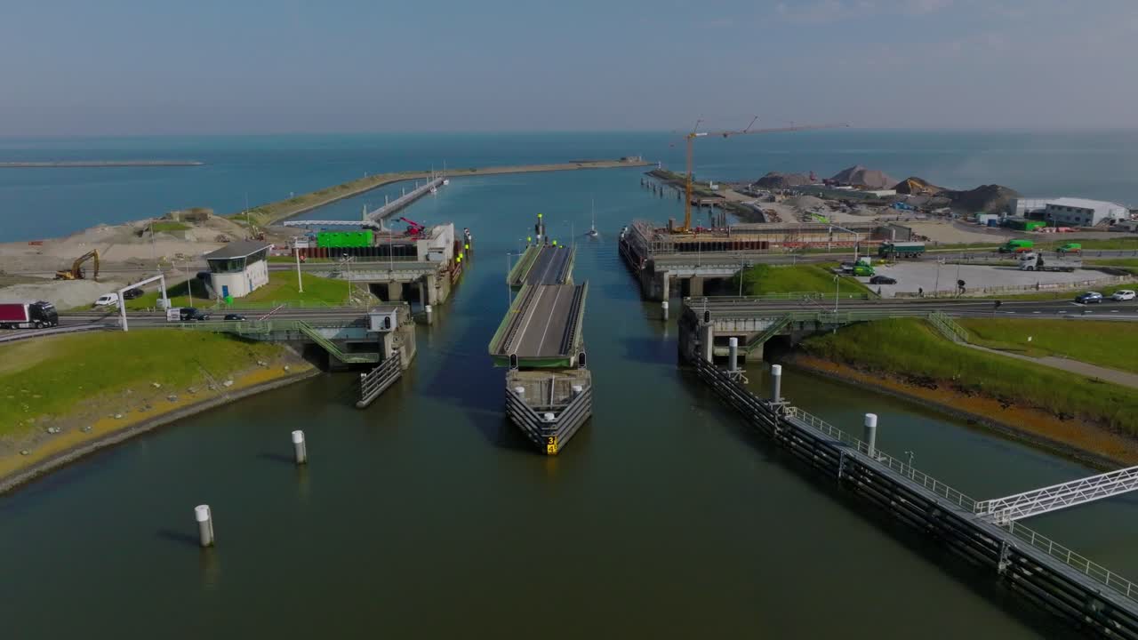 Aerial semi orbit showing the Afsluitdijk locks system and surrounding highway structures along the Dutch coastline