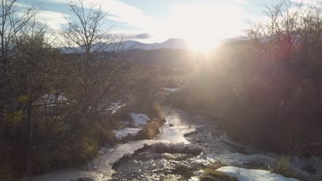 TILT-UP-Sun-beams-lighting-a-brook-on-mountain-landscape