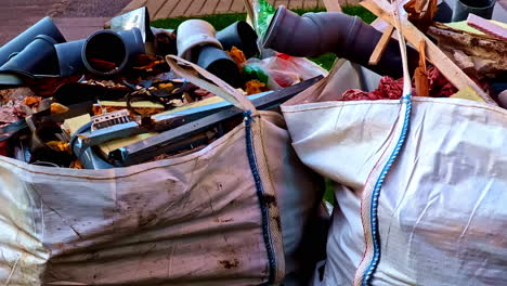 construction waste and debris piled in large bags outdoors