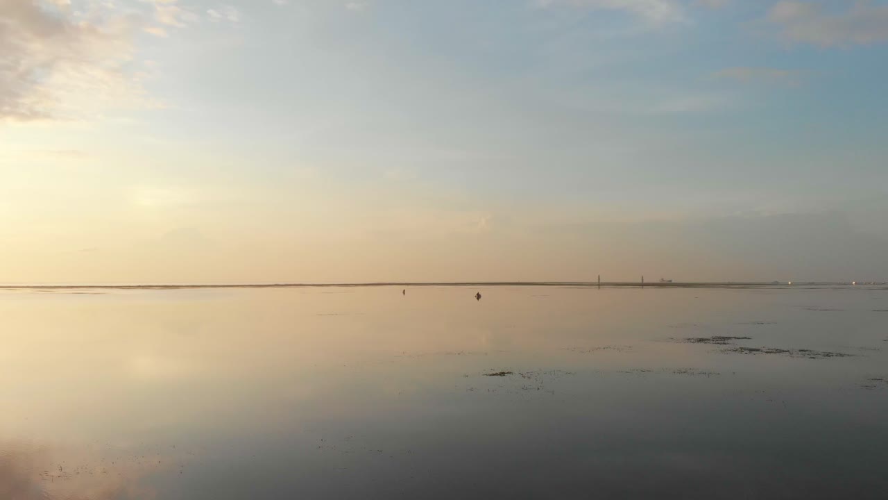 Aerial view of peaceful Sanur beach with sunrise over the Indian Ocean in Bali Indonesia