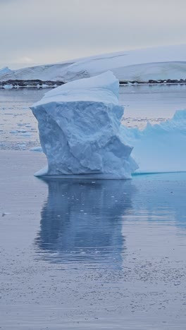 antarctica iceberg ice formation floating on ocean sea water, vertical video for social media, instagram reels and tiktok, antarctic peninsula winter landscape scenery and ice landscape