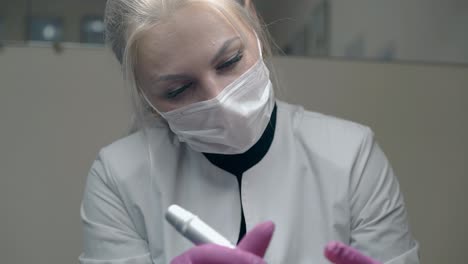 lady-with-blond-ponytail-applies-permanent-eyebrow-make-up