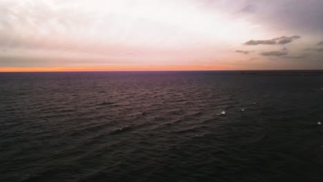 sunset colors splashing along lake michigan during cloud cover
