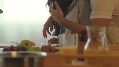 Happy-couple-preparing-breakfast-together