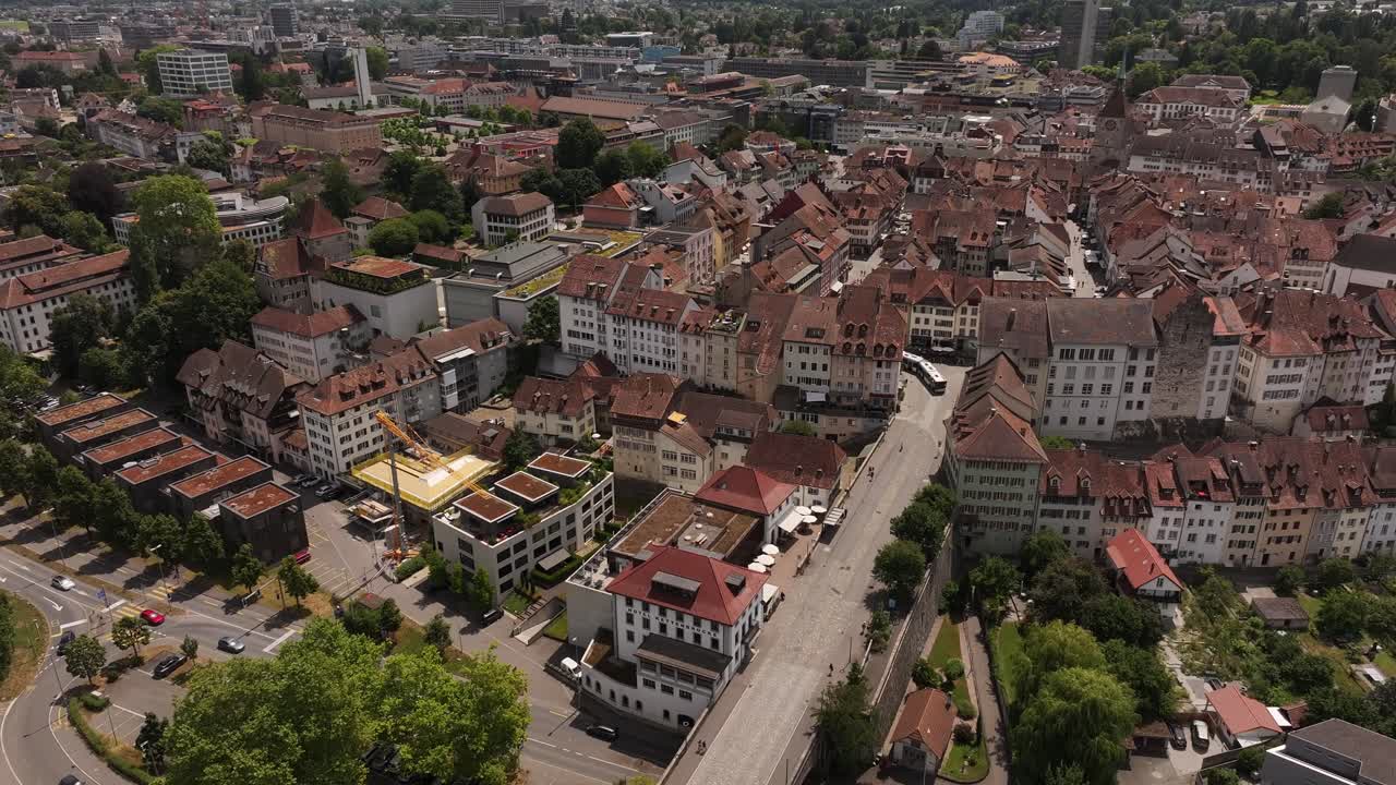 Beautiful drone aerial view of Aarau city with historic old town, rooftops and bridge crossing
