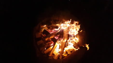 a top-down shot of a flaming camp fire in slow motion