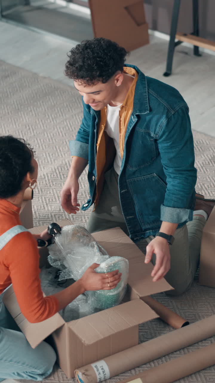 Young Couple Unpacking Boxes Together in Their New Home