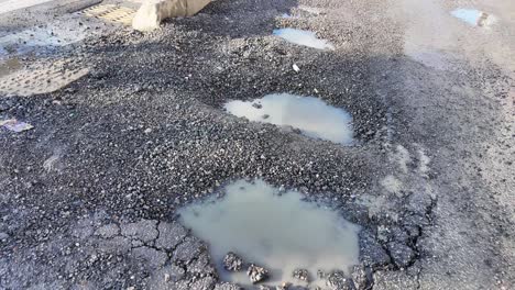 potholes and water puddle on a road