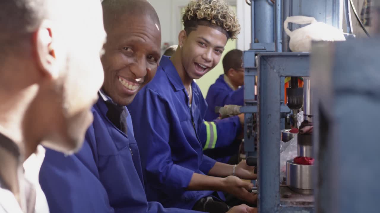 Group of mixed race men working in factory