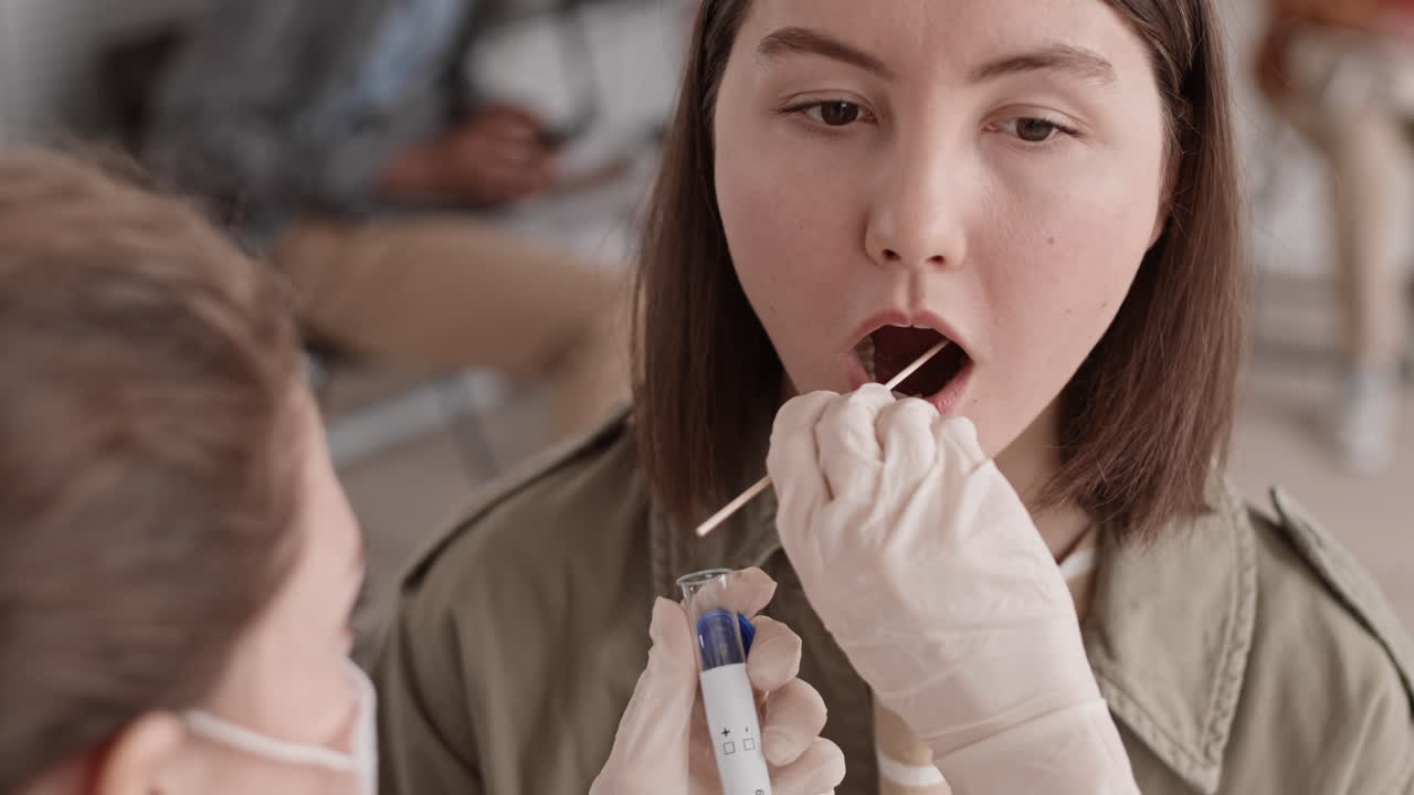 Unrecognizable Nurse Taking Saliva Sample