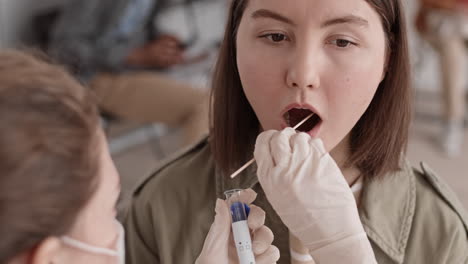 Unrecognizable Nurse Taking Saliva Sample