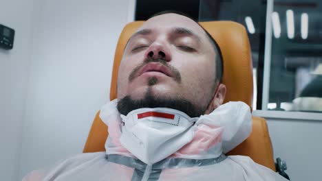 tired doctor taking off face shield and mask exhausted emergency medicine worker taking off face shield and mask and leaning back on chair to take deep breath while riding ambulance to hospital during epidemic