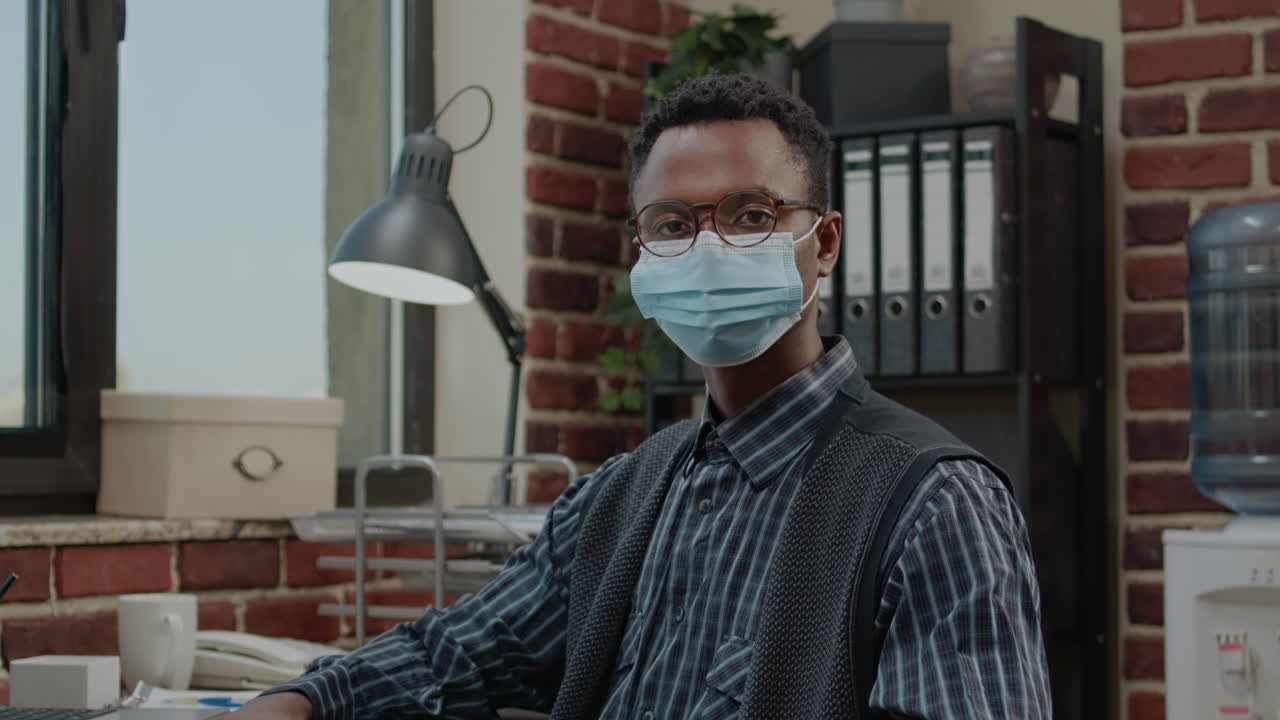 Portrait of business man wearing face mask in startup office