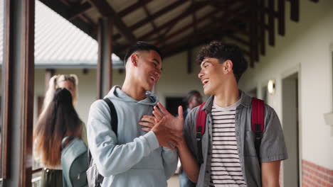 Two teenage students chatting in a school hallway