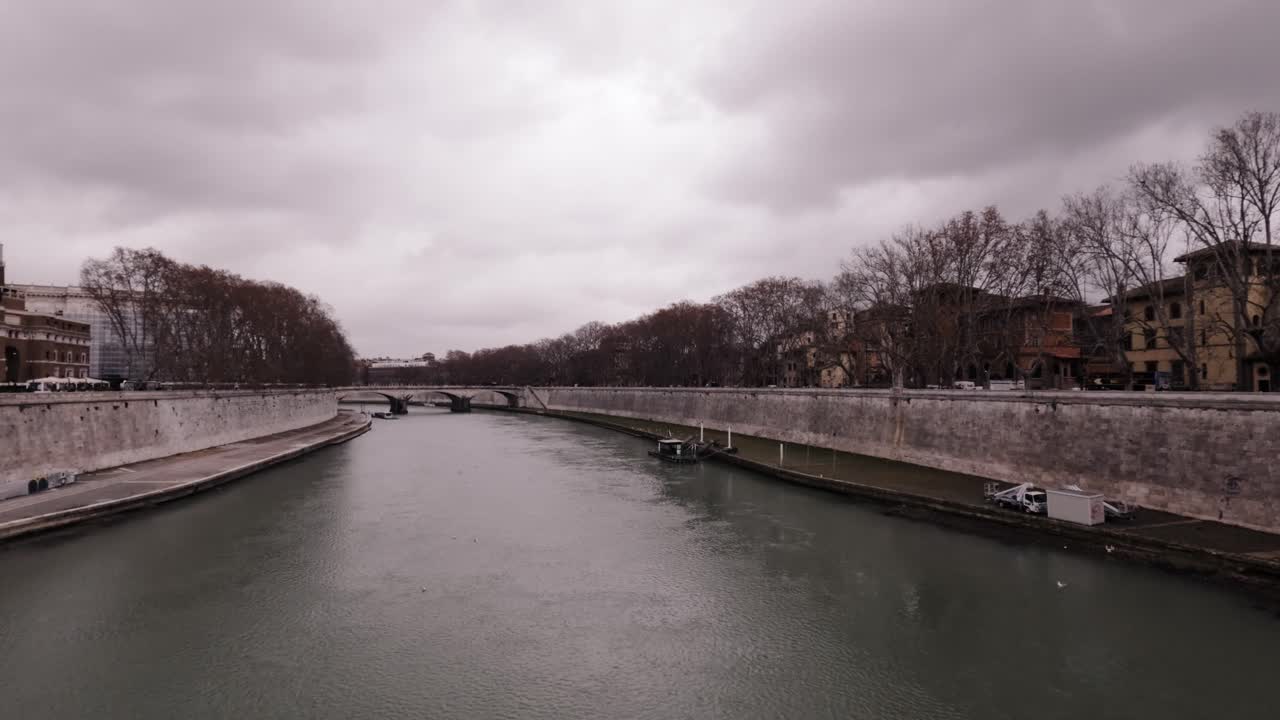 Exploring historic riverside buildings in cloudy weather by the water in Rome