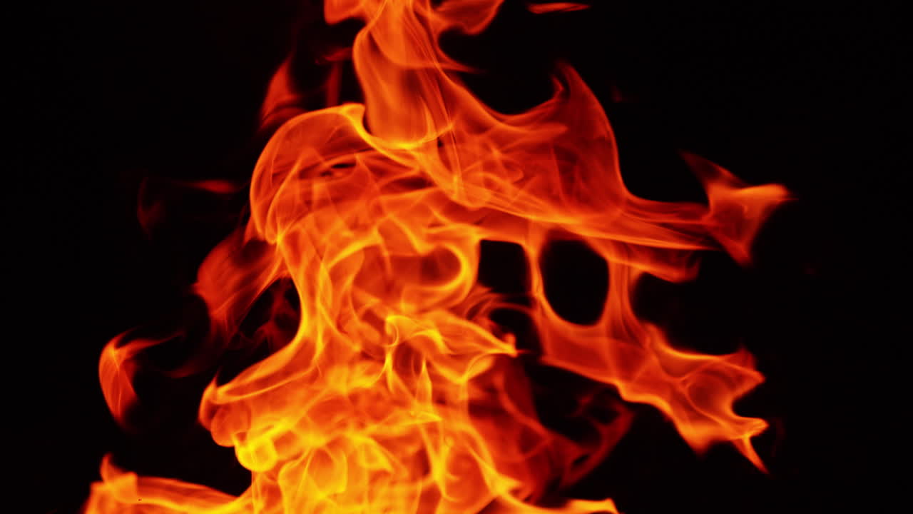 Top part of the bonfire burning in the darkness. Beautiful fire flames dancing in the night. Close up.