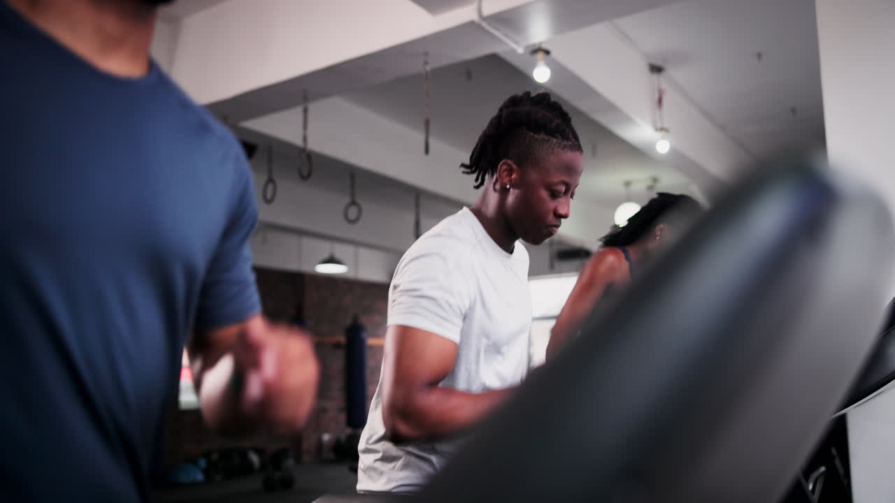 People working out on treadmills in a gym.