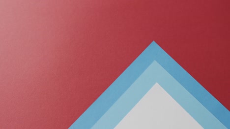 close up of blank and blue cards on red background with copy space in slow motion