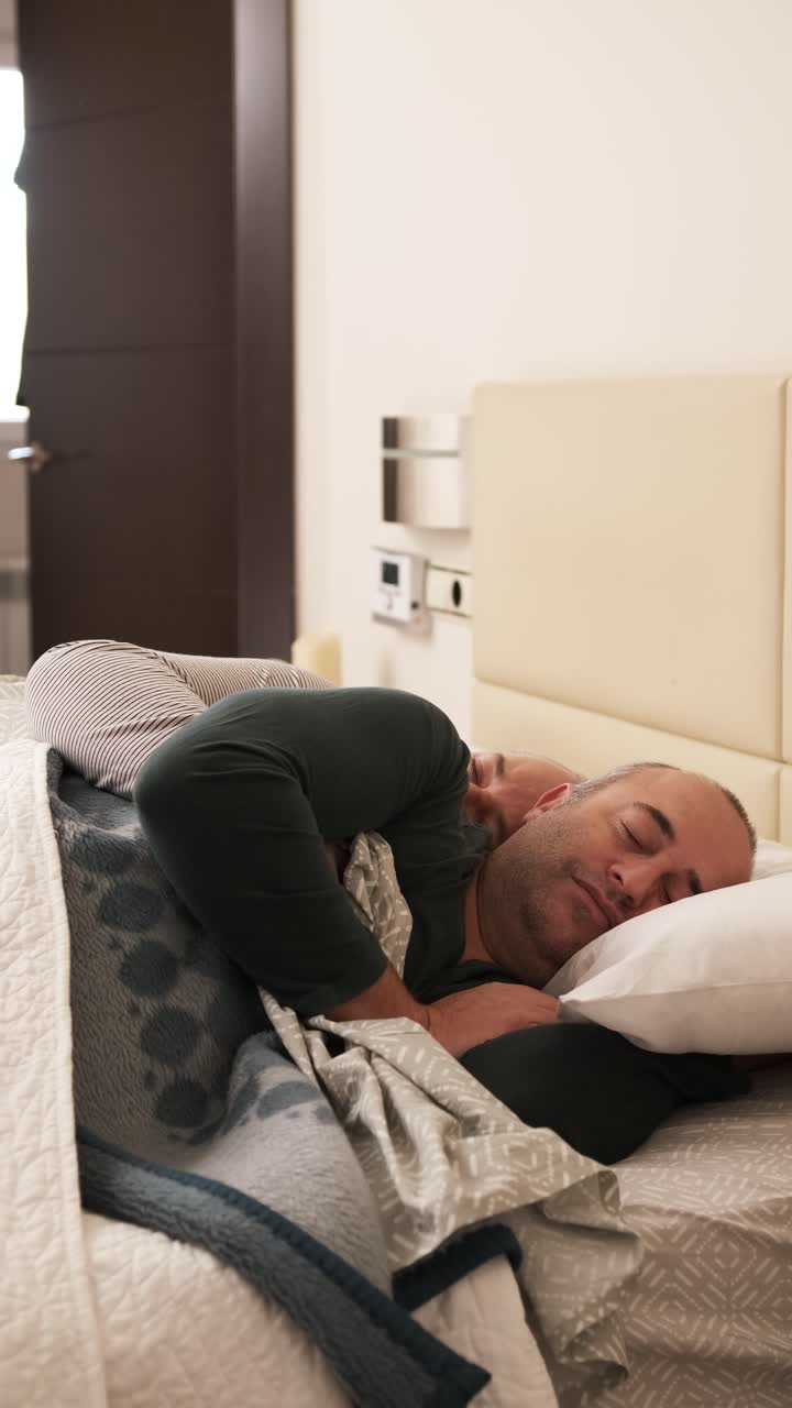 Homosexual male couple sleeping relaxed at home