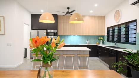 sideways wipe of a modern contemporary open plan kitchen dining aria with island bench and breakfast bar