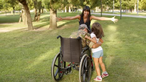 excited kids with mom running to disabled retired military dad