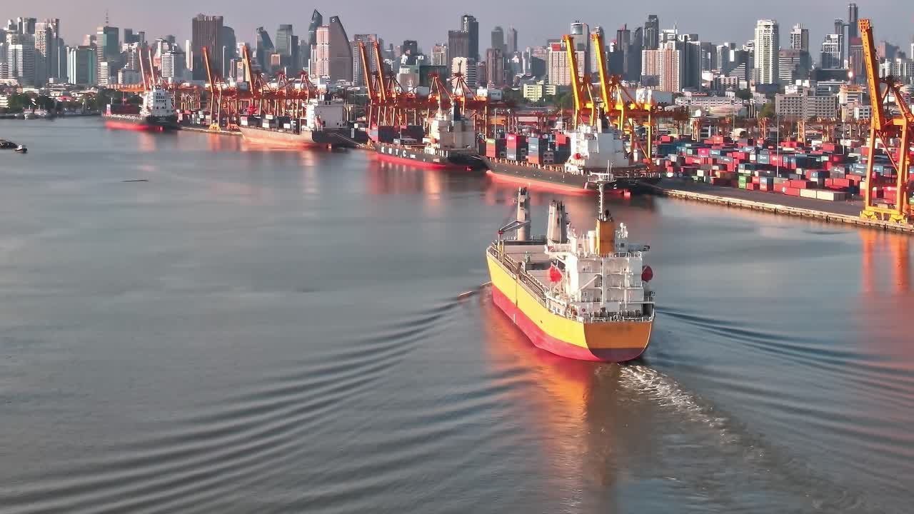 Shipping vessels move past the busy port in Bangkok during daylight