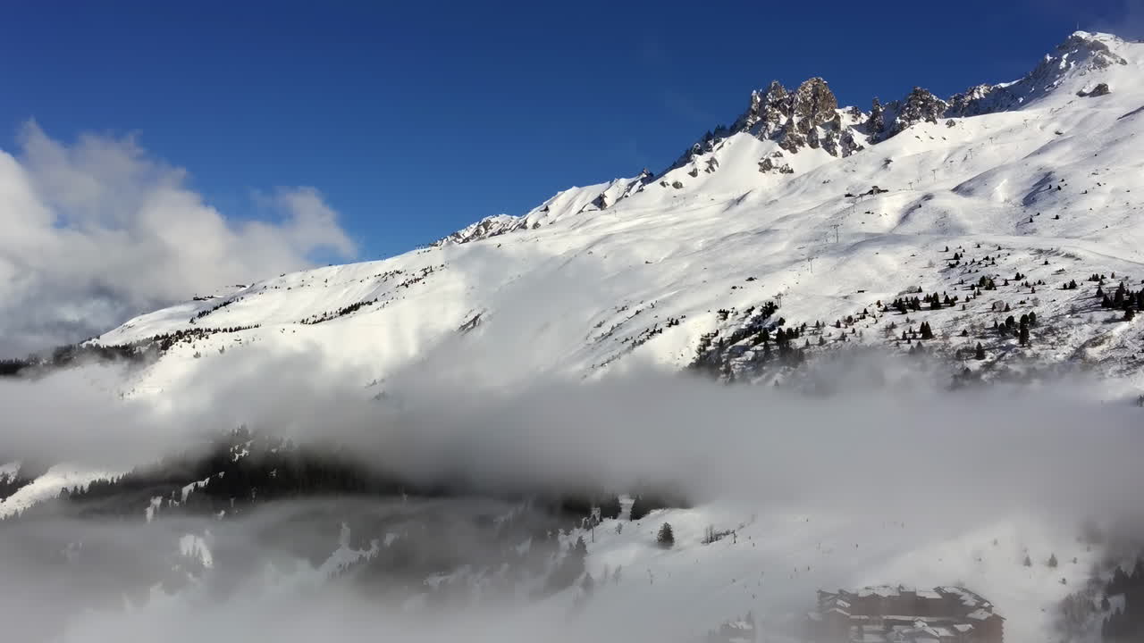 View of snow on the trees and mountains in Les Belleville, France